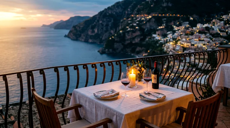 Candlelit dinner table for two on Positano seaside terrace at golden hour with Mediterranean sea view.