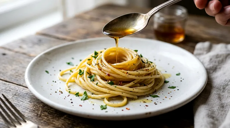 Colatura drizzled onto fresh pasta during Cetara food tasting.